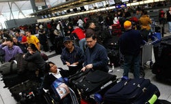 People line up while waiting for a flight